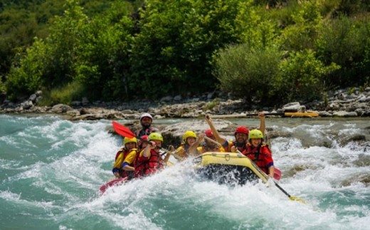 A group of people white water rafting