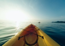 A Kayak on water with sun shining, perfect for a peaceful adventure.